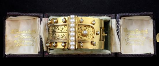 A late Victorian 18ct gold and split pearl hinged bracelet,